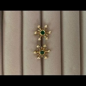 14k gold with center emerald stone and diamonds.